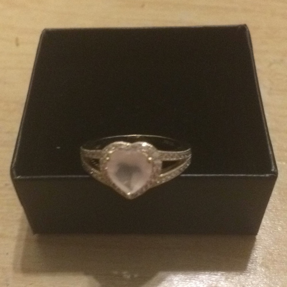 A very light pink heart ring